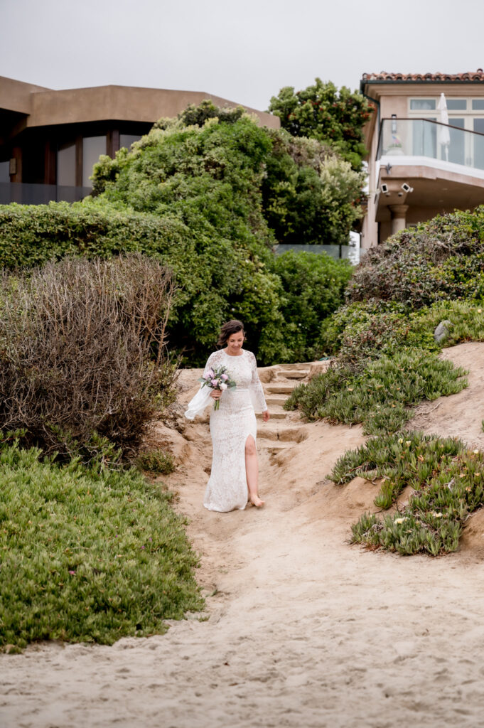 Bride walking down to the beach for wedding ceremony