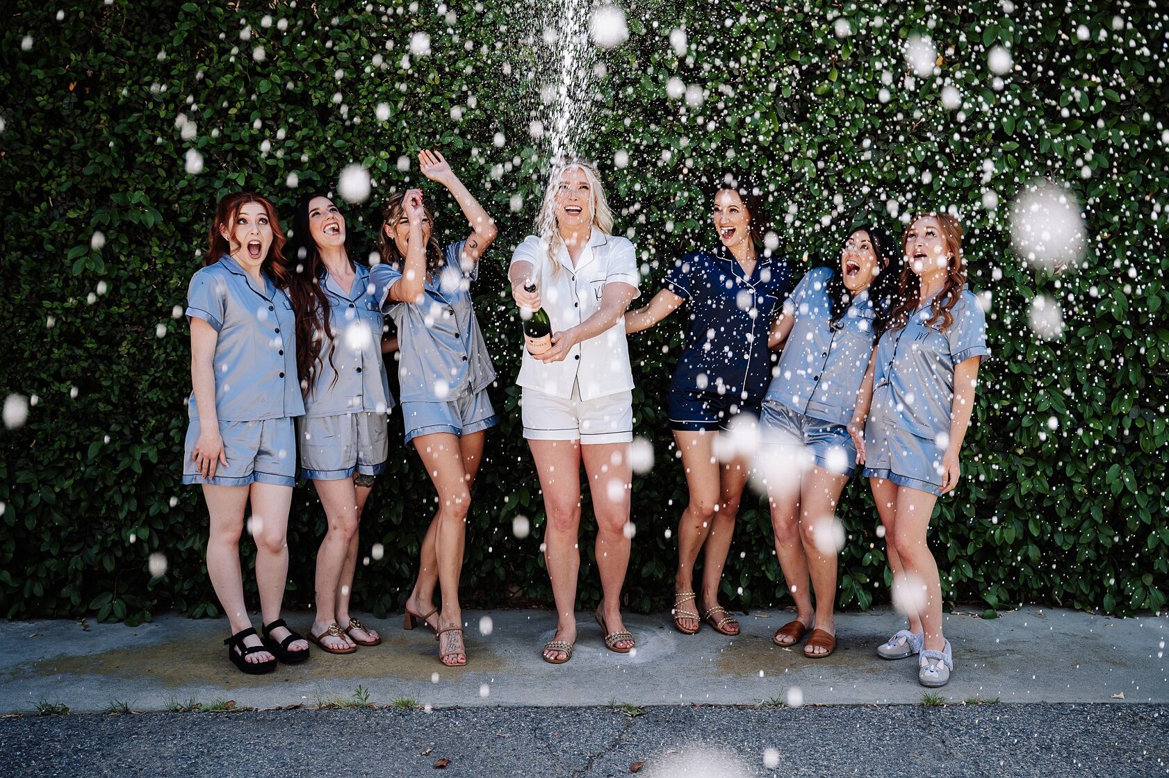 Bridesmaids popping Champagne